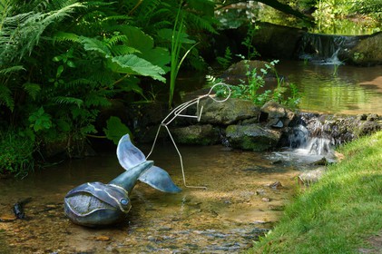 En hommage au poète, ses amis dont Gérard Fusberti, propriétaire du terrain et gardien du temple, décident de créer un jardin où chacun plantera son arbre ou laissera une de ses créations. Montand, Reggiani, Greco ou Mouloudji plantèrent chacun leur double végétal lors de la célébration du dixième anniversaire de la mort de Prévert, un eucalyptus aujourd'hui haut d'au moins 20 mètres pour Mouloudji.Se balader dans ce jardin, c'est pénétrer dans l'univers du poète. Au milieu des arbres d'ornement, des bambous peints de rouge vif, des arbres fruitiers, des camélias, des azalées, des gunneras (que Prévert adorait) et des hortensias, des œuvres d'art se révèlent ça et là, tantôt un portrait, tantôt une sculpture ou une installation. Des arbres peints prennent vie, une main rouge semblant sortir de leur entrailles, le ruisseau qui coule en cascade murmure une douce poésie, que l'on retrouve en quelques phrases inscrites sur des plaques qui surgissent au milieu de cette jungle organisée. (Saint-Germain-des-Vaux Manche)