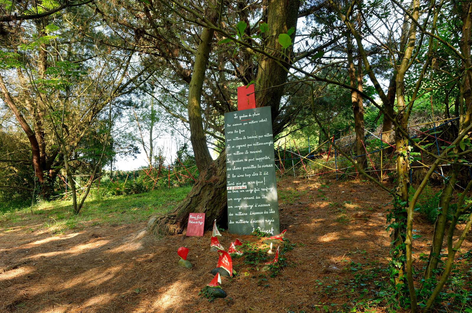 En hommage au poète, ses amis dont Gérard Fusberti, propriétaire du terrain et gardien du temple, décident de créer un jardin où chacun plantera son arbre ou laissera une de ses créations. Montand, Reggiani, Greco ou Mouloudji plantèrent chacun leur double végétal lors de la célébration du dixième anniversaire de la mort de Prévert, un eucalyptus aujourd'hui haut d'au moins 20 mètres pour Mouloudji.Se balader dans ce jardin, c'est pénétrer dans l'univers du poète. Au milieu des arbres d'ornement, des bambous peints de rouge vif, des arbres fruitiers, des camélias, des azalées, des gunneras (que Prévert adorait) et des hortensias, des œuvres d'art se révèlent ça et là, tantôt un portrait, tantôt une sculpture ou une installation. Des arbres peints prennent vie, une main rouge semblant sortir de leur entrailles, le ruisseau qui coule en cascade murmure une douce poésie, que l'on retrouve en quelques phrases inscrites sur des plaques qui surgissent au milieu de cette jungle organisée. (Saint-Germain-des-Vaux Manche)
